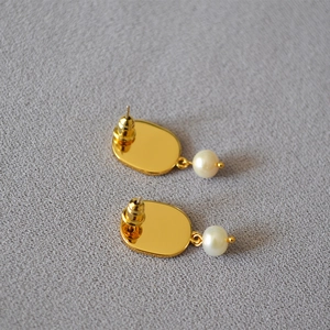 Pastel enamel grape earrings with 925 silver pins and pearls on a textured background