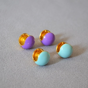 Detail view of purple and blue enamel hoops in polished gold plated brass finish