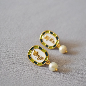Detail of handmade enamel grape earrings with gold-plated brass and freshwater pearl