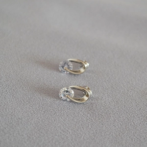 Close-up of minimalist silver stud earrings with sparkling round cubic zirconia stones