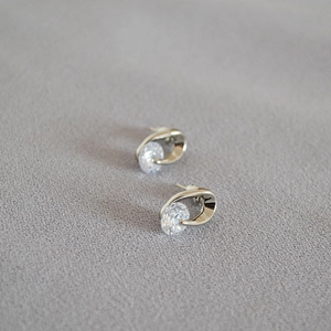 Macro shot of silver stud earrings with sparkling cubic zirconia in a streamlined design