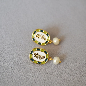 Detailed macro view of vintage enamel grape earrings with pearls and 18k gold plating