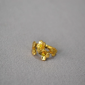 Detailed close-up of adjustable enamel cherry blossom ring with yellow gemstone centers