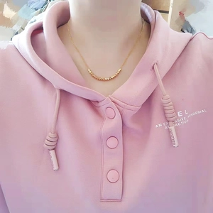 Minimalist gold-plated brass necklace with geometric square beads worn on neck