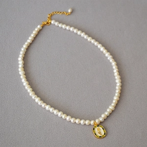 Vintage irregular freshwater pearl necklace with gold leaf enamel grape pendant