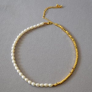 Detail of freshwater pearl and faceted gold bead necklace with adjustable lobster clasp