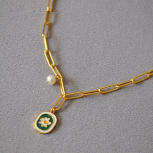 Gold paperclip necklace with white pearl and green enamel daisy pendant
