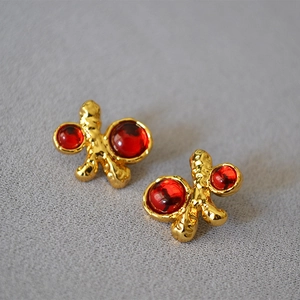 Retro palace style irregular gold earrings with deep red gemstones and hammered texture