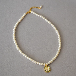 Vintage necklace with freshwater pearls and green enamel pendant featuring Double Happiness