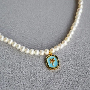 Vintage pearl necklace with blue enamel palm tree pendant and irregular freshwater pearls