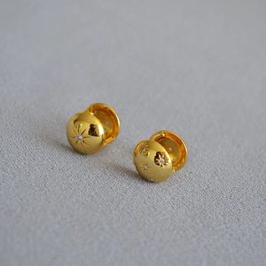 Gold-plated brass huggie earrings with engraved North Star and zircon inlays