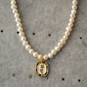 Detail view of oval grape pendant with colorful enamel and freshwater pearls