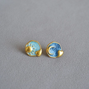 Asymmetric sun and moon enamel stud earrings with golden hearts and marble blue finish