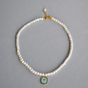 Vintage pearl necklace with blue enamel palm tree pendant and golden S-clasp finish