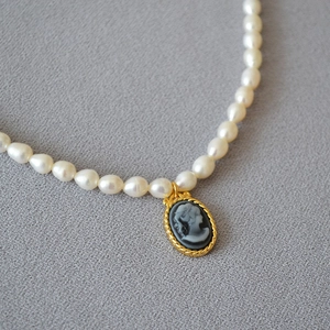 French vintage freshwater pearl necklace with black oval cameo relief pendant and gold trim