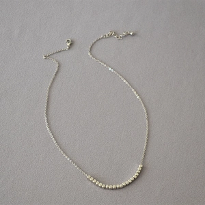 Minimalist silver chain necklace featuring polished square beads and a lobster clasp closure