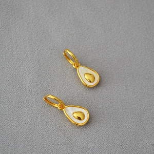 Detailed view of pear-shaped gold-plated earrings with white mother-of-pearl inlay