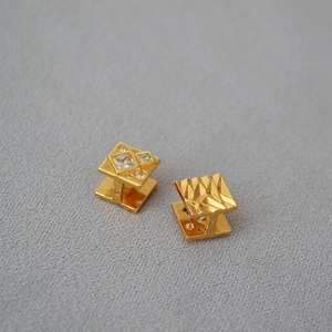 Irregular textured gold plated brass earrings with square cubic zirconia stone