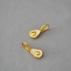 Detail of pear-shaped brass gold earrings with mother-of-pearl inlay in avocado design