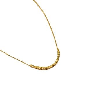Minimalist gold plated brass necklace featuring a row of faceted square metal beads