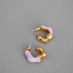 Detail of gold-plated wavy C-shaped earrings with lavender enamel and silver pins