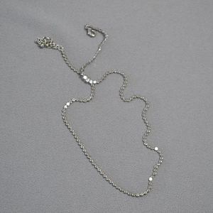 Minimalist silver choker necklace with polished metal discs and lobster clasp closure