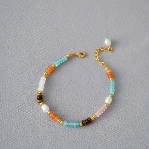 Close-up of color-block beaded necklace with freshwater pearls and tiger eye stones