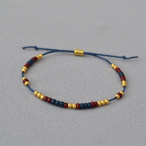 Handmade beaded bracelet with minimalist blue cord and adjustable golden slider clasp