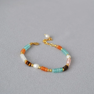 Close-up of multicolored beads and freshwater pearls on a minimalist choker necklace