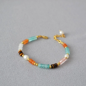 Close-up of beaded necklace with freshwater pearls and colorful gemstones with lobster clasp