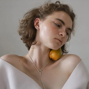 Detail of a minimalist silver Y-shaped long necklace with sleek geometric metal links