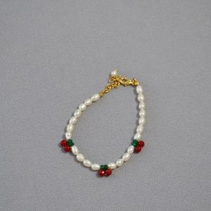 Handmade freshwater pearl bracelet with red cherry accents and golden adjustable clasp