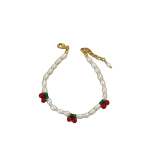 Adjustable freshwater pearl bracelet with red cherry accents and golden lobster clasp