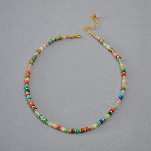 Detail of colorful square beads necklace with gold spacers and adjustable clasp