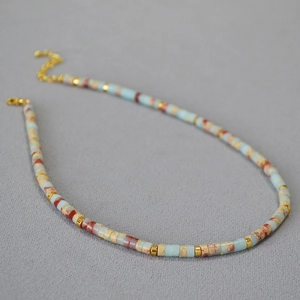 Close-up of Bohemian beaded necklace with blue stones and gold-toned metal spacers