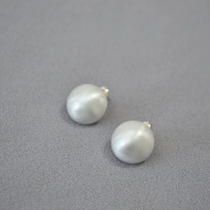 Detail of matte brushed semi-sphere stud earrings with 925 silver needles