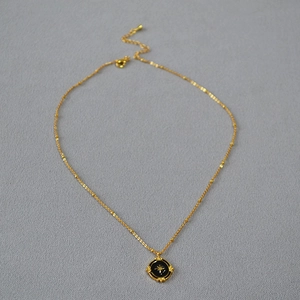 French vintage gold necklace with black enamel North Star oval pendant on beaded chain