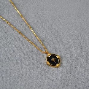 Elegant gold bead chain necklace with vintage black enamel North Star oval pendant