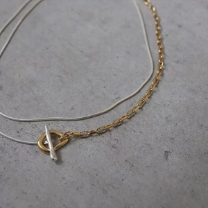Detail of minimalist two-tone double layer necklace with gold and silver OT buckle closure