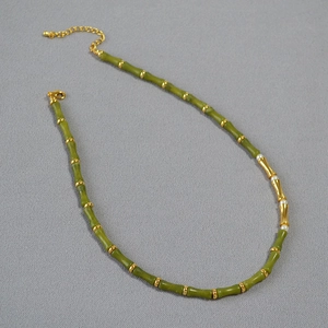 Detail of green bamboo style beads with gold spacers and elegant white pearls