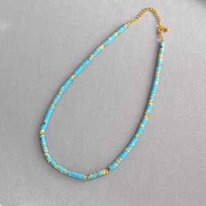 Bohemian turquoise beaded necklace with gold spacers and adjustable lobster clasp