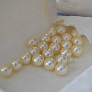Macro shot of minimalist 925 silver large pearl stud earrings with high luster finish