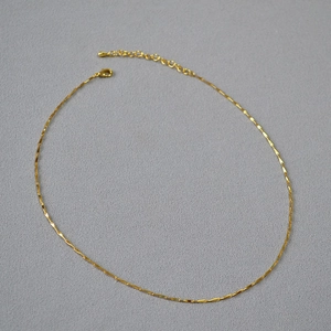 Minimalist gold plated brass choker necklace featuring delicate twisted chain with lobster clasp