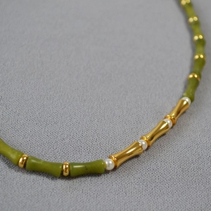 Detail of green jade-like bamboo beads with gold metal joints and small pearls