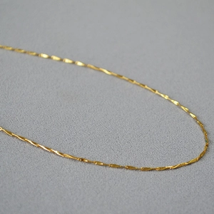 Minimalist gold plated brass twisted blade chain necklace with sparkling metal texture