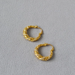 Gold twisted hoop earrings with shimmering cubic zirconia accents in a spiral design