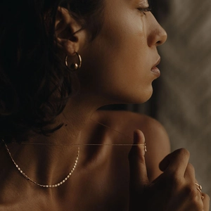Minimalist 18K gold plated lace chain necklace and ball hoop earrings on female model