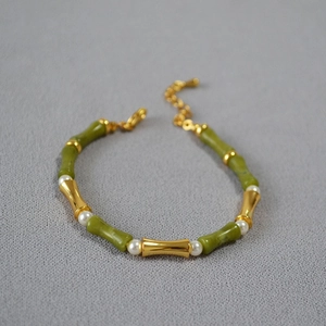 Detail of bamboo joint necklace with green jade, white pearls and gold chain