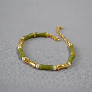 Detail of green bamboo style bead necklace with gold accents and white pearls