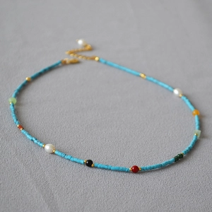 Detail of vintage French beaded necklace with blue turquoise and white pearls